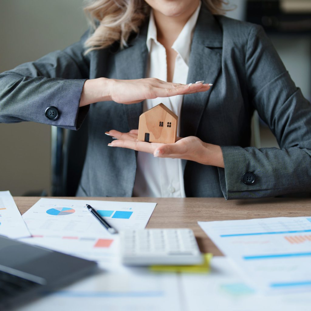 portrait of an asian man, Agent, buy and sell land, property tax, show the concept of protecting the house to insure the risk of damage to the home.
